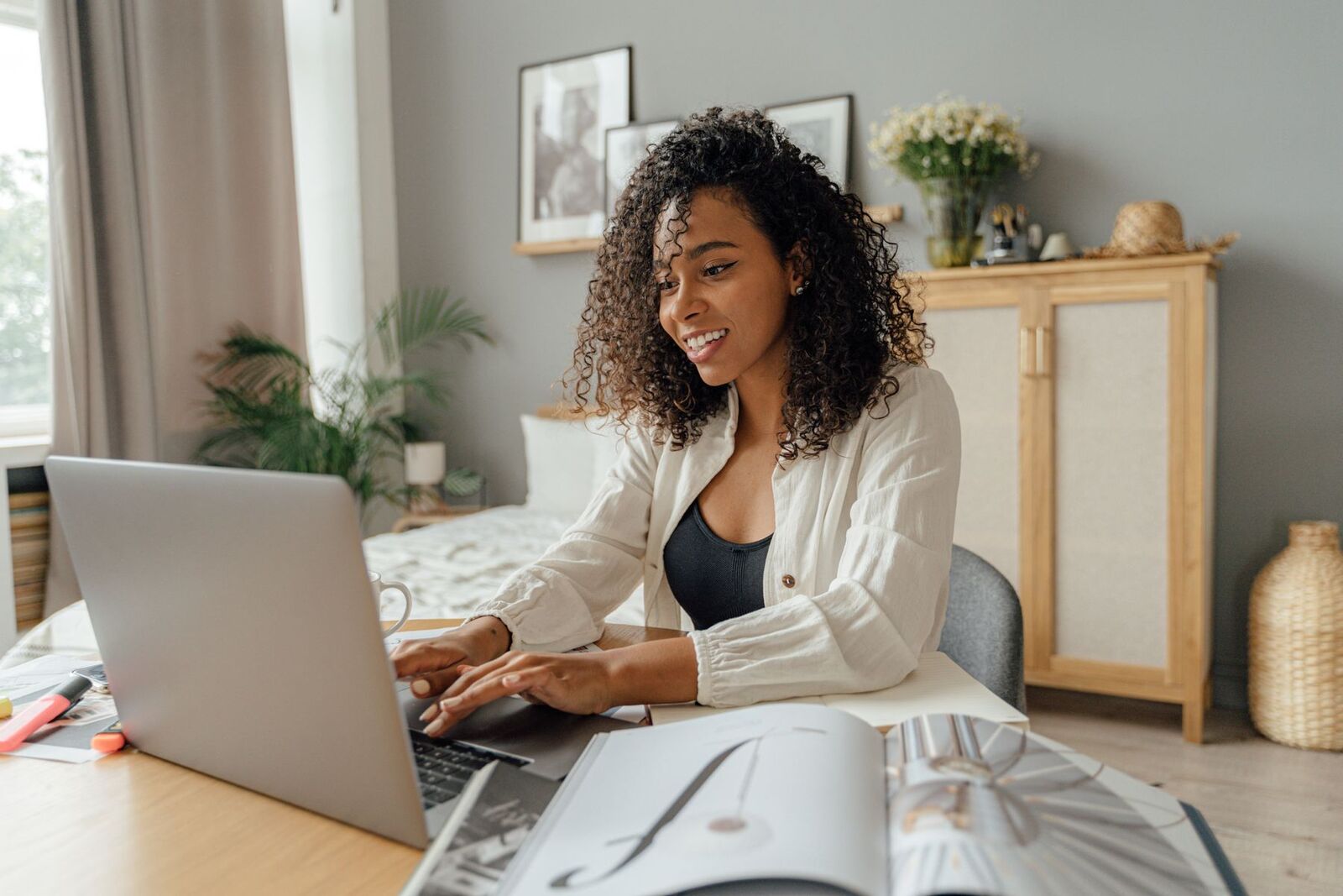 Woman working on a laptop at home in natural light