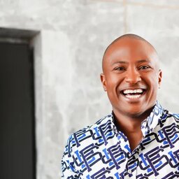 MJ Harris smiling in a patterned shirt